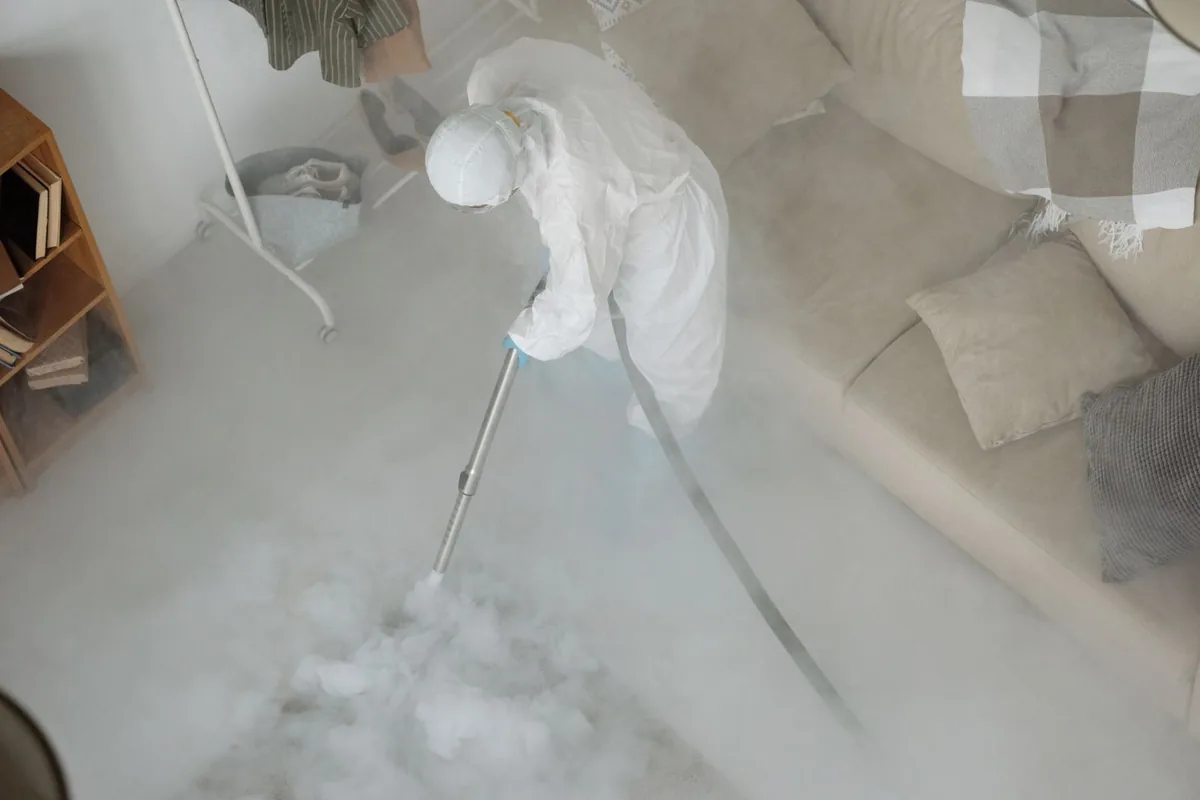 Biohazard cleanup technician in protective equipment, Anthony, TX